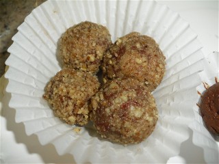 Chocolate balls covered in pecan pieces.