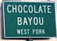 Chocolate Bayou highway sign with a chocolate name on it.