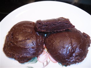 Three homemade fudgie chocolate cookies on a plate.