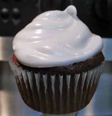 Chocolate cupcake with white frosting.