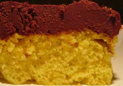 chocolate ganache frosting on yellow cake