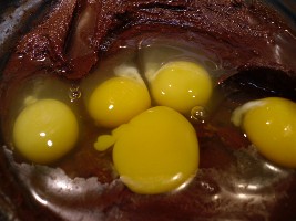 Eggs being added to molten lava cake batter.