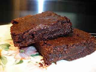 Dark chocolate brownies on a plate.
