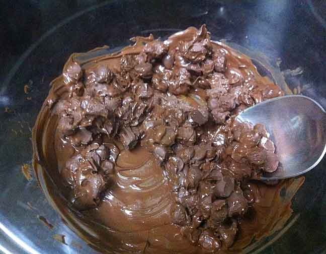 A bowl of partially melted milk chocolate chips.
