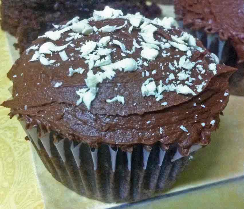 Death by chocolate cupcake with white chocolate shavings.