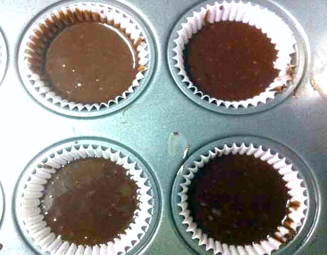 Fudge cupcake batter in the cupcake tin ready to bake.