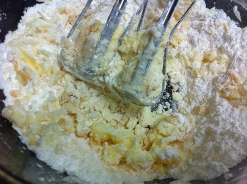 Partially beaten butter, vanilla and powdered sugar.