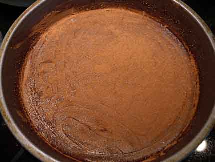 Cake pan greased and dusted with cocoa powder.