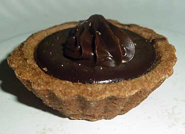 Larger-than-life picture of a delcious chocolate mini pie bite.
