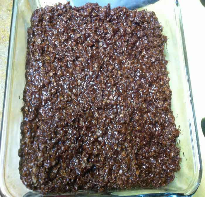 Cookie batter pressed into a dish to be cut into squares.