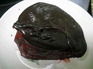 Slice of Pillsbury Red Velvet cake with homemade fudge icing .