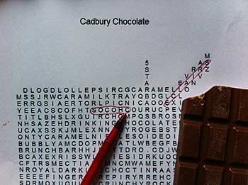 Chocolate word search puzzle with pen and chocolate bar.