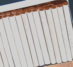 A pile of chocolate cigarettes. Wikimedia added color to enhance.